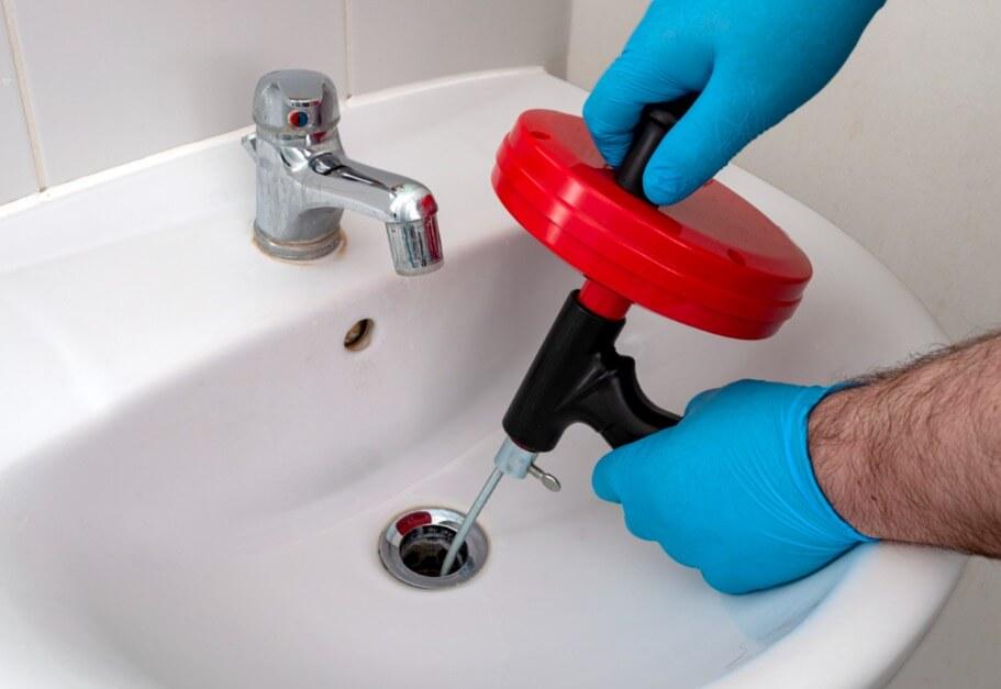 slow draining, gurgling noises, and water backups are common signs that you may need drain cleaning